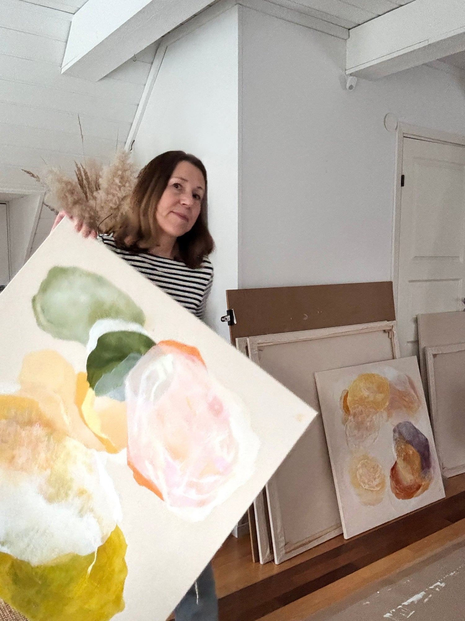 Studio pic with me holding my artwork Oneness, nature inspired modern abstract art in acrylic. Ingeborg Andersson Art