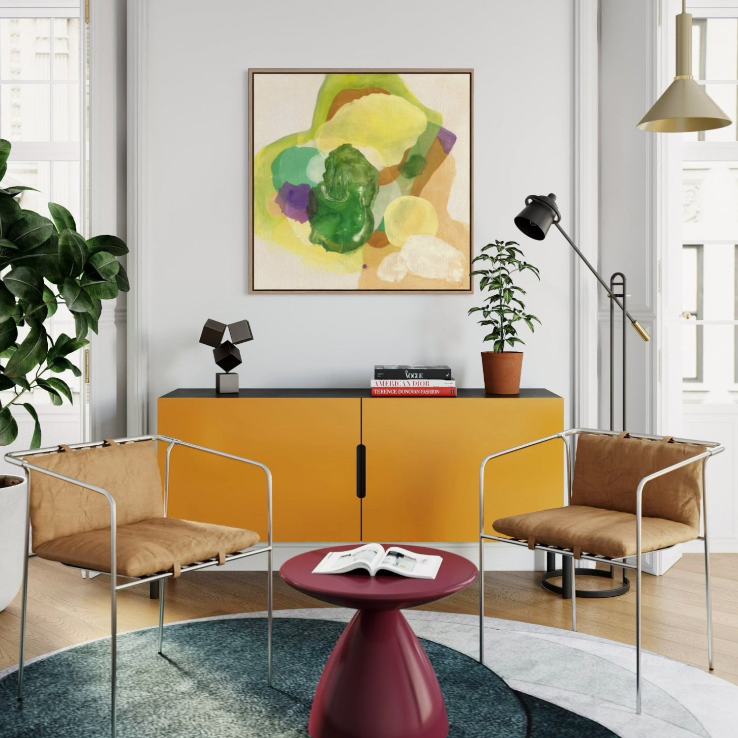 The Frog, Abstract Fine Art Print on Canvas in a floating frame of sustainable sourced wood in a natural finish. This artwork has nature inspired abstract shapes with playful movements in  green, white, violet, sand tones, yellow-greenish. Hanging in a modern living room, on a bright wall, a warm yellow cabinet beneath with a plant and books on the black shelf. Two modern chairs in metal frame and leather seating with a wine red small round  table.Petroleum blue round carpet. Ingeborg Andersson Art