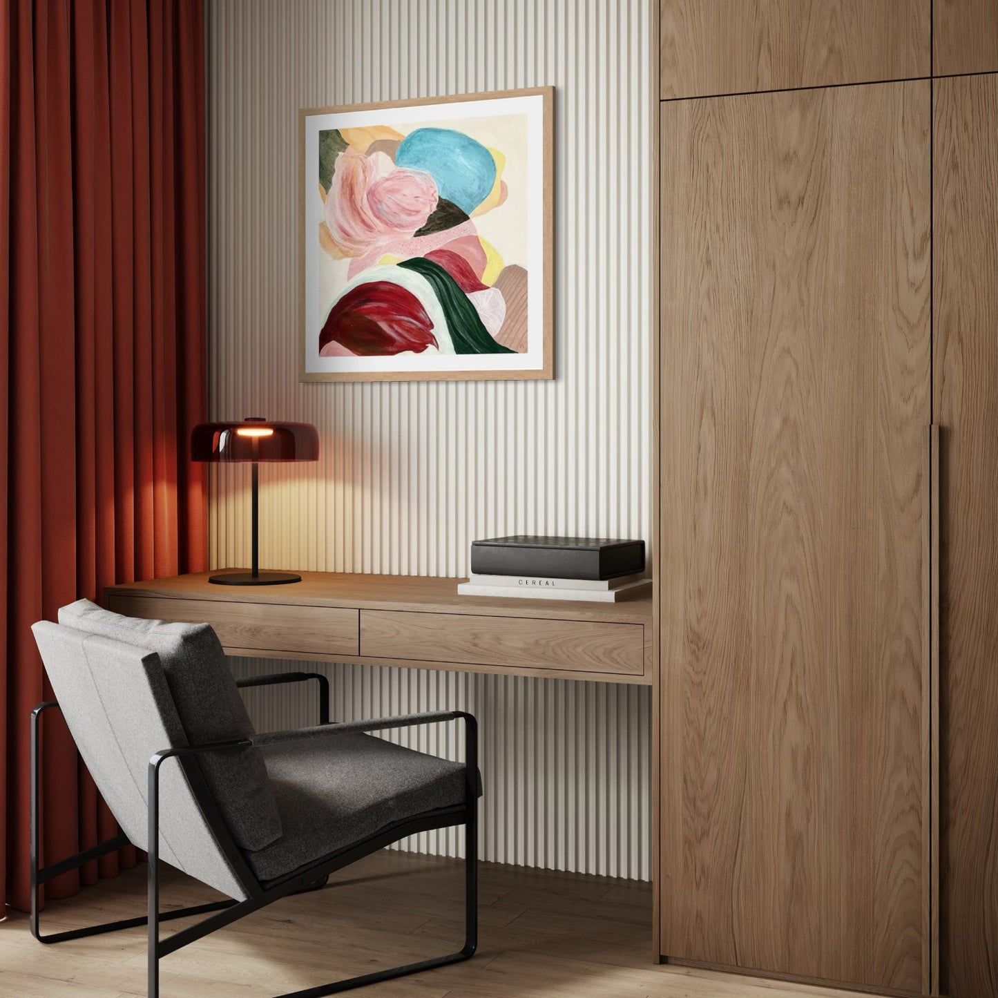 There is so much to tell, Abstract Fine Art Print on Paper with a classic frame of sustainable sourced wood in a natural finish. This artwork has nature inspired abstract shapes with playful movements. Green, white, orange, yellow, pink, wine-red, sand, blue. Hanging on a white wall in modern nook above a working desk and cupboards in dark oak, table lamp in copper, long soft red curtains. A grey modern lounge chair.  Ingeborg Andersson Art
