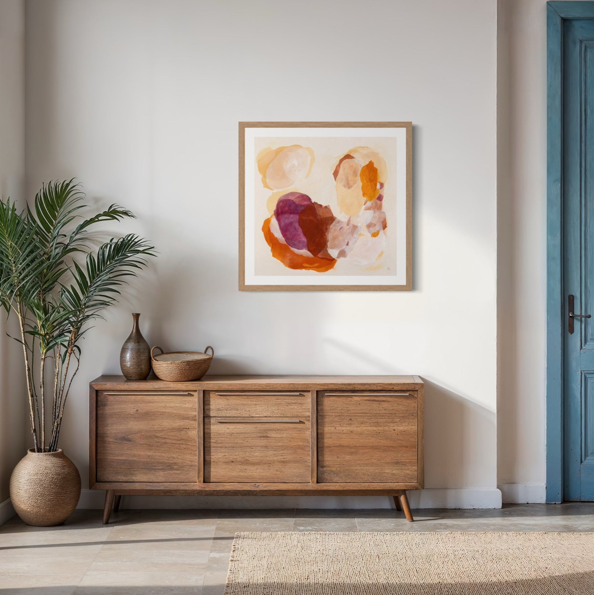 Caramel, soulful abstract art print with rich burgundy and warm peach organic shapes and layered textures on paper. Hanging in a modern hallway. Ingeborg Andersson Art