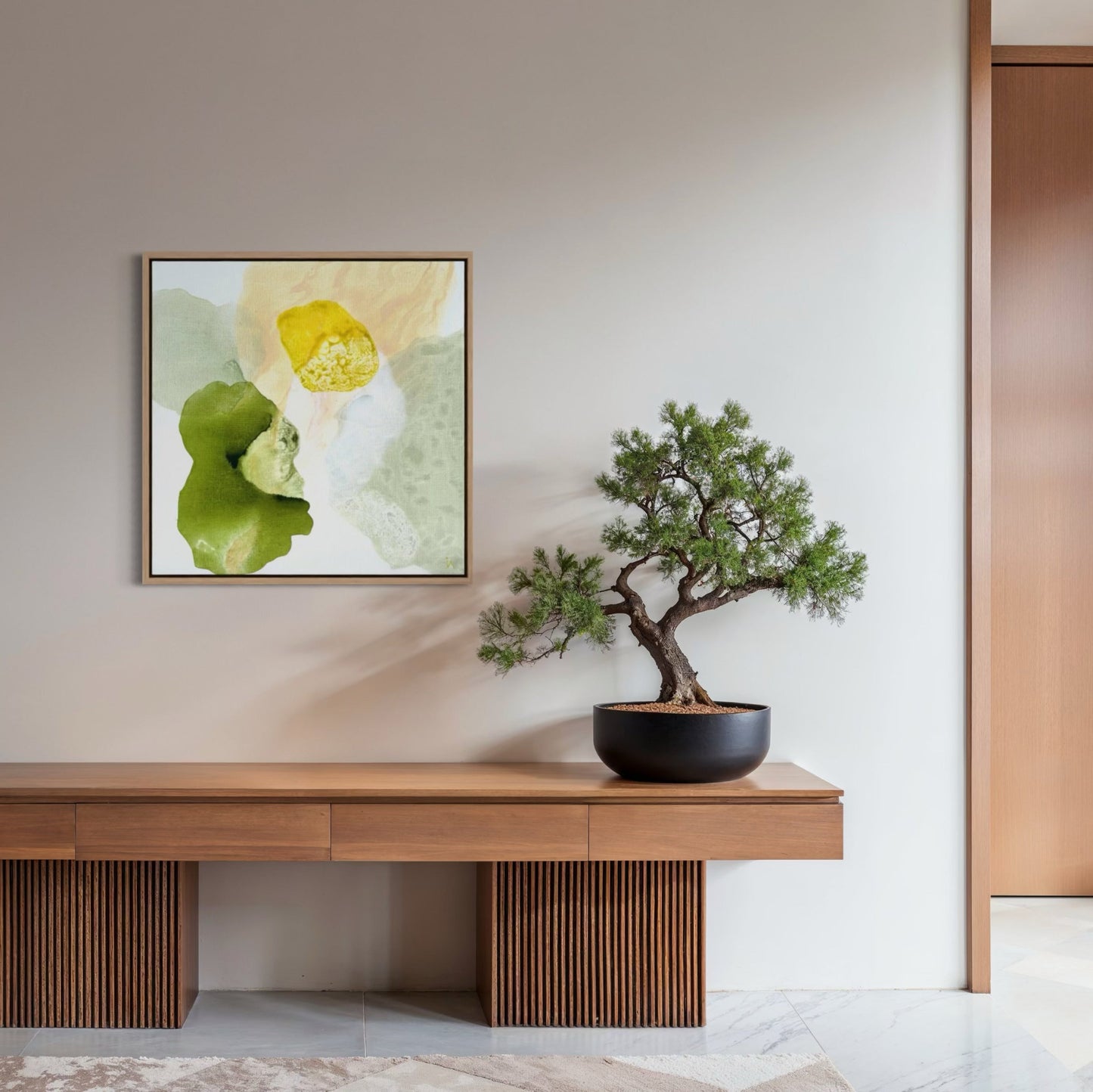 Yellow Diamond, modern abstract wall decor print in a natural frame with luminous gold and soft yellow tones and delicate shimmer texture. Hanging in a hallway, japandi style.  Ingeborg Andersson Art
